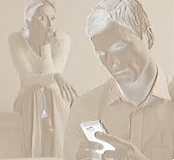Woman looking on with concern while a man checks his phone.